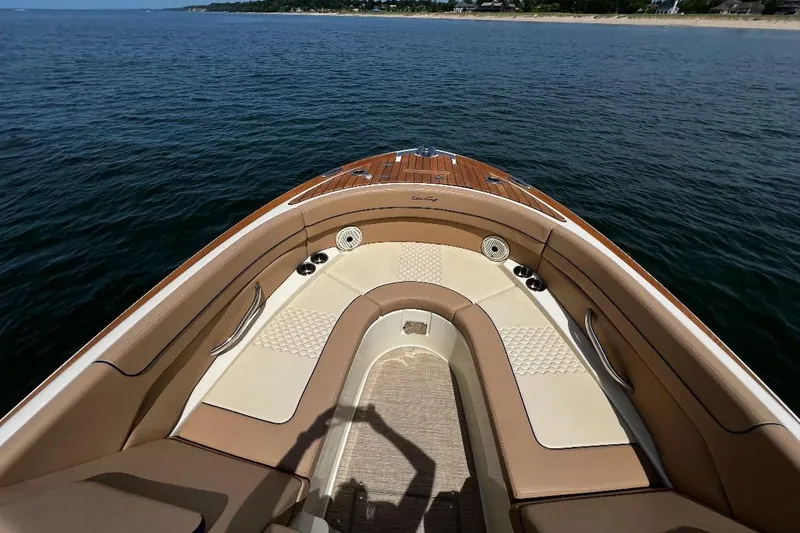 Slide: The Image of 2025 Chris-Craft Launch 28 GT boat interior with luxurious seating on calm water. - 20