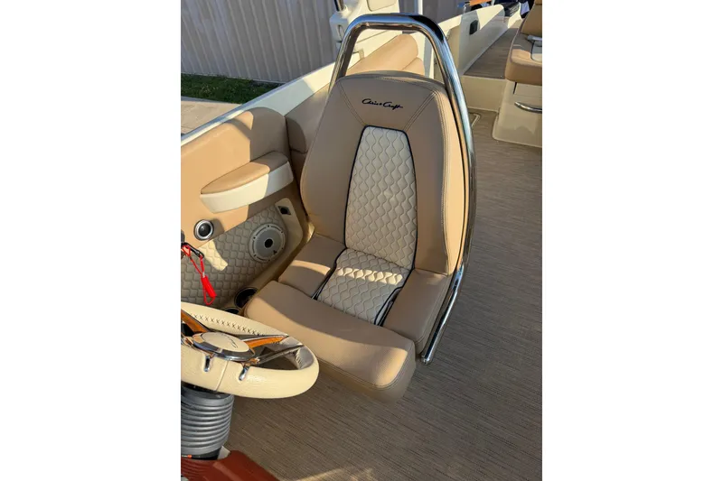 Slide: The Image of Luxurious interior of 2025 Chris-Craft Launch 28 GT boat with elegant seating and steering wheel. - 25