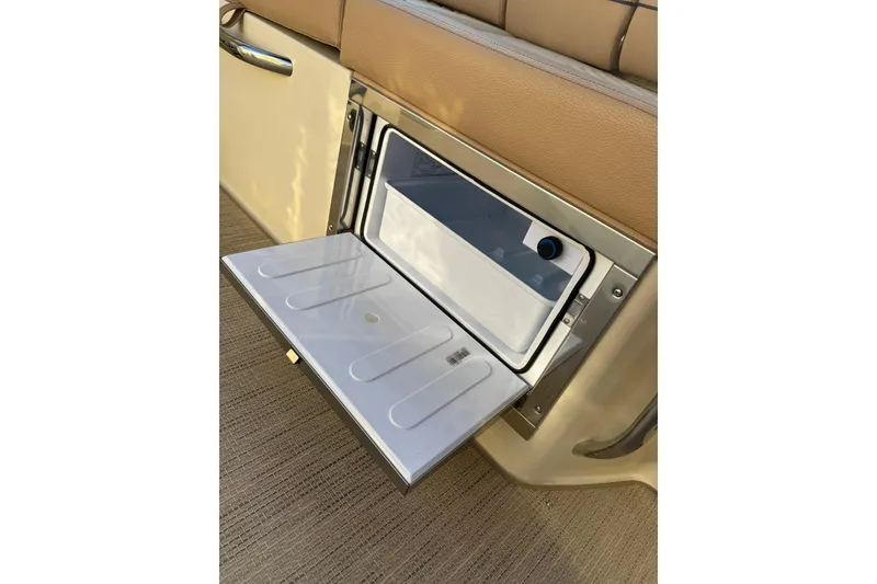 Slide: The Image of 2025 Chris-Craft Launch 28 GT interior storage compartment with open lid, showcasing sleek design. - 28
