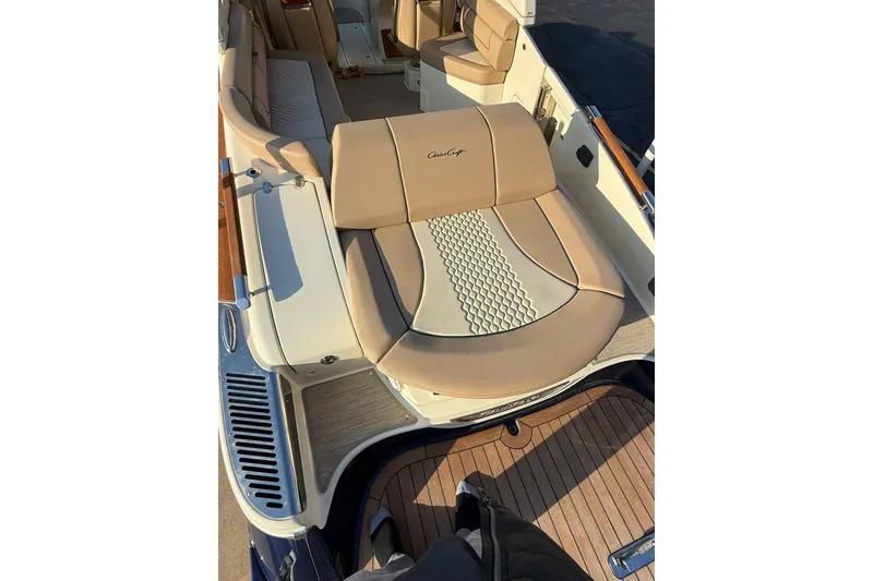 Slide: The Image of 2025 Chris-Craft Launch 28 GT boat interior with beige seating and wood accents. - 30