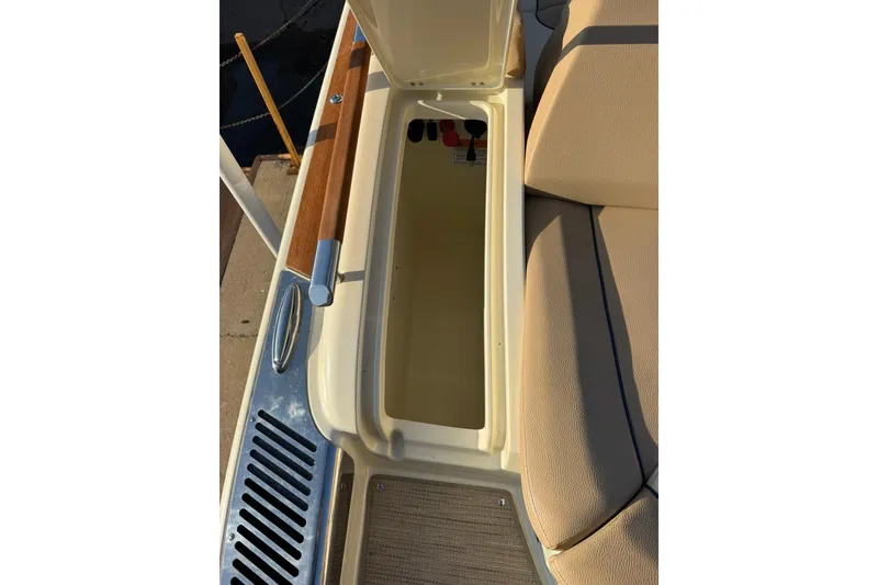 Slide: The Image of 2025 Chris-Craft Launch 28 GT storage compartment with open lid, showcasing interior space. - 31
