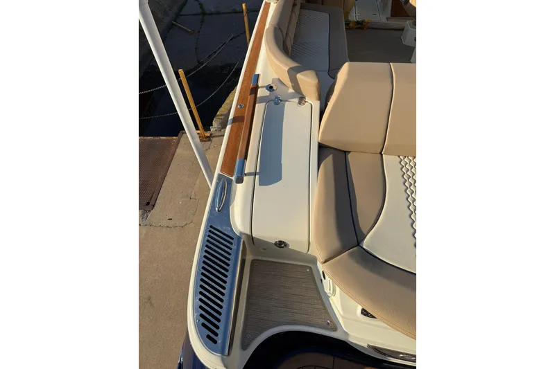 Slide: The Image of 2025 Chris-Craft Launch 28 GT boat interior with beige seating and wooden accents. - 32