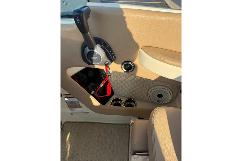 Slide: The Image of Interior of 2025 Chris-Craft Launch 28 GT, featuring control panel and beige upholstery. - 33