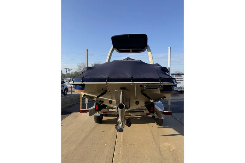 Slide: The Image of 2025 Chris-Craft Launch 28 GT boat, rear view on trailer, covered, sunny day. - 36