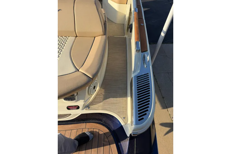 Slide: The Image of 2025 Chris-Craft Launch 28 GT boat interior with beige seating and wooden accents. - 39