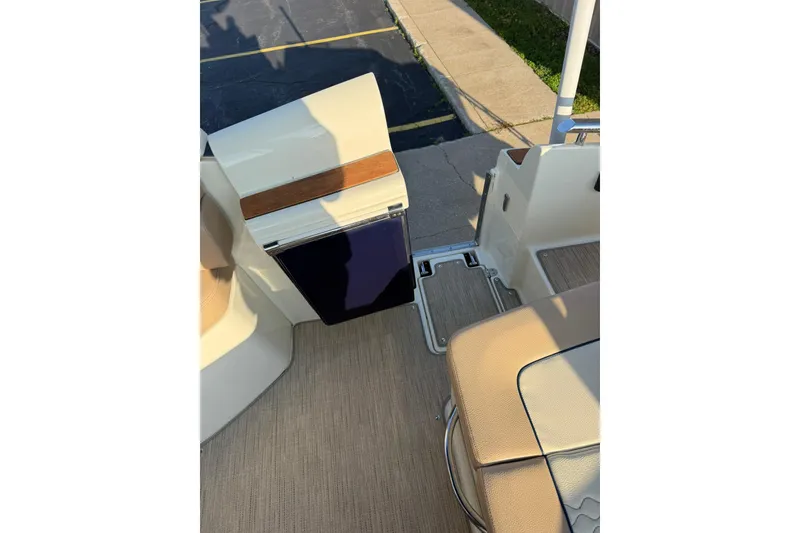 Slide: The Image of 2025 Chris-Craft Launch 28 GT interior with beige seating and wooden accents. - 40