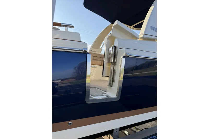 Slide: The Image of 2025 Chris-Craft Launch 28 GT boat with open side door, showcasing sleek design. - 41