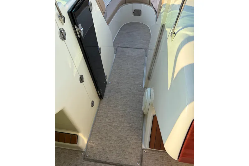 Slide: The Image of 2025 Chris-Craft Launch 28 GT interior walkway with sleek design and modern finishes. - 44