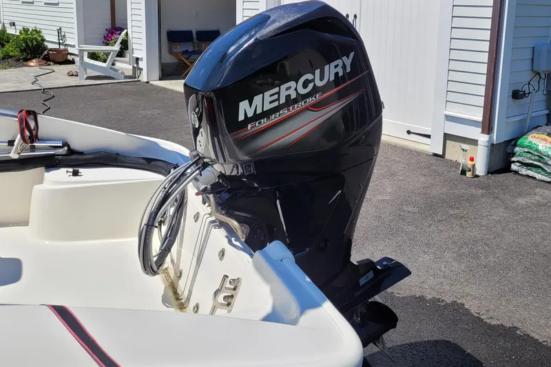 Slide: The Image of 2010 Boston Whaler 150 Super Sport with Mercury FourStroke engine in driveway. - 4
