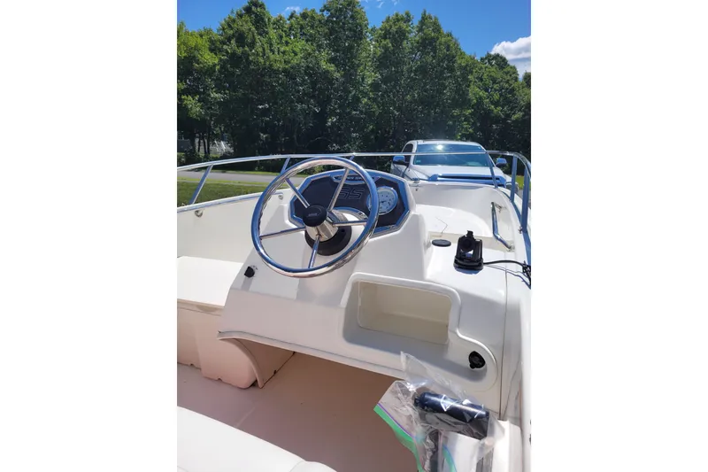 Slide: The Image of 2010 Boston Whaler 150 Super Sport boat interior with steering wheel and dashboard. - 5