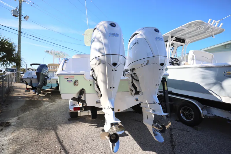 Slide: The Image of 2026 Sea Hunt Ultra 265 SE boat with dual outboard engines in a marina setting. - 11