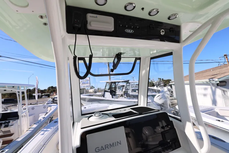 Slide: The Image of 2026 Sea Hunt Ultra 265 SE boat interior with Garmin navigation system. - 12