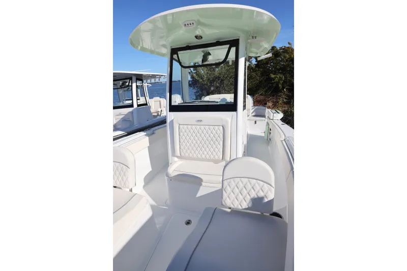 Slide: The Image of 2026 Sea Hunt Ultra 265 SE boat interior with white seating and console. - 14