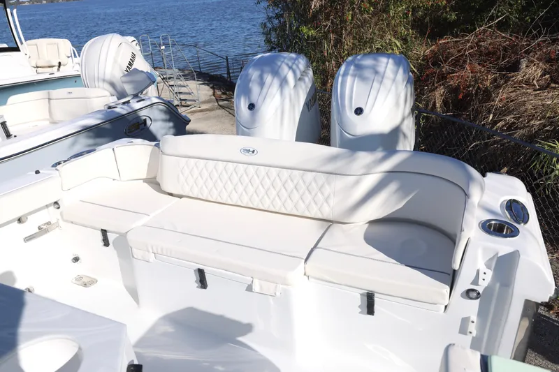 Slide: The Image of 2026 Sea Hunt Ultra 265 SE boat with dual Yamaha engines and white seating. - 18