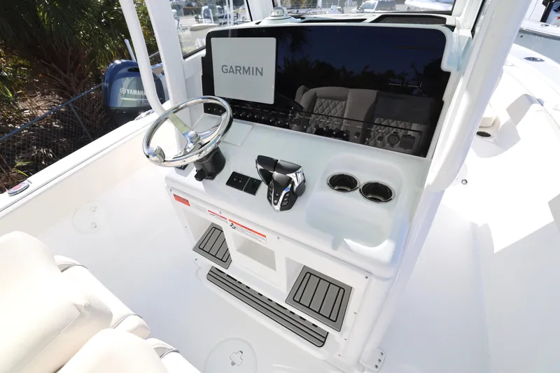 Slide: The Image of 2026 Sea Hunt Ultra 265 SE boat console with Garmin display and Yamaha controls. - 23