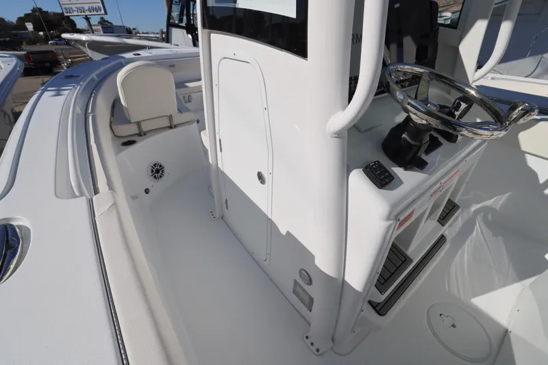 Slide: The Image of 2026 Sea Hunt Ultra 265 SE boat interior with steering console and seating. - 26