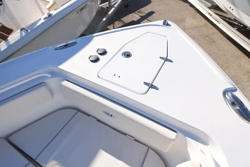 Slide: The Image of 2026 Sea Hunt Ultra 265 SE boat deck with storage compartment and seating. - 29