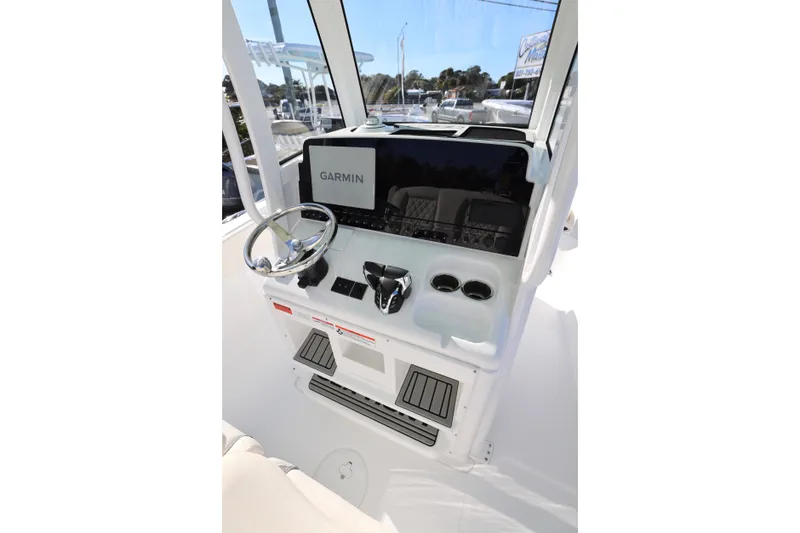 Slide: The Image of 2026 Sea Hunt Ultra 265 SE boat console with Garmin display and steering wheel. - 3