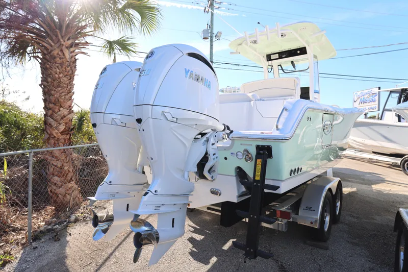 Slide: The Image of 2026 Sea Hunt Ultra 265 SE boat with dual Yamaha outboard engines on a trailer. - 5