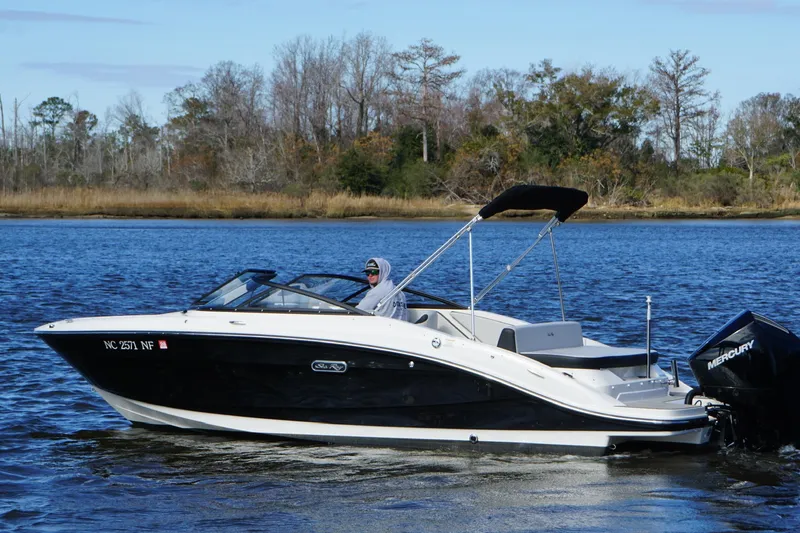Slide: The Image of 2025 Searay SPX210 boat cruising on a serene lake with scenic background. - 10