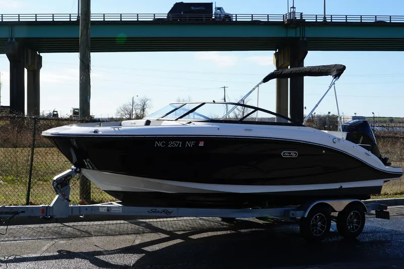 Slide: The Image of 2025 Searay SPX210 boat on trailer under bridge, side view. - 14
