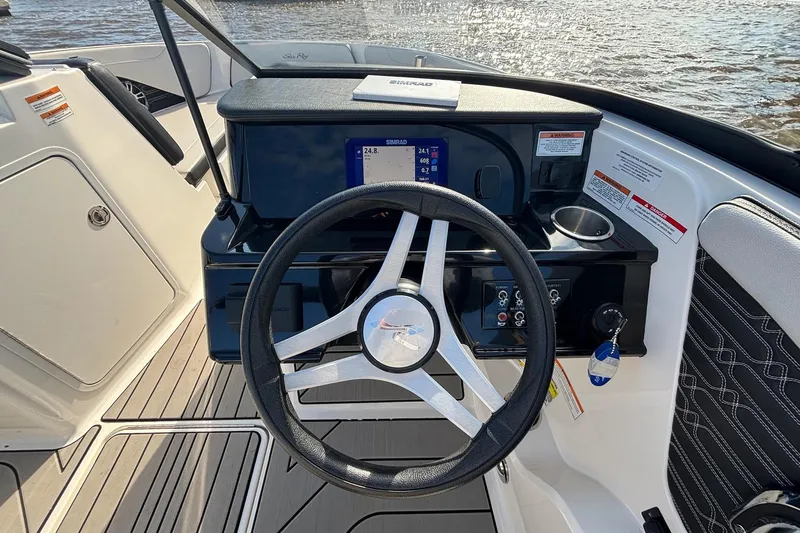 Slide: The Image of 2025 Sea Ray 21 SPX OB boat dashboard with steering wheel and navigation display. - 16