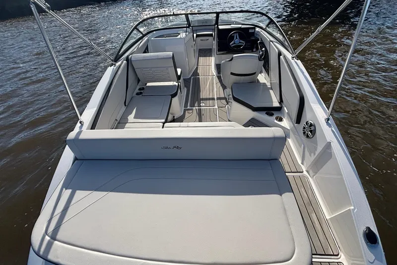 Slide: The Image of 2025 Sea Ray 21 SPX OB boat interior with sleek seating and modern design on water. - 17