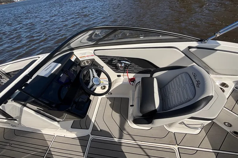 Slide: The Image of 2025 Sea Ray 21 SPX OB boat cockpit with steering wheel and comfortable seating. - 24