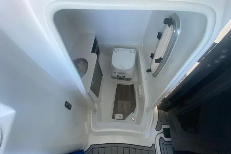 Slide: The Image of 2022 Monterey M-65 boat interior with compact bathroom and toilet. - 14