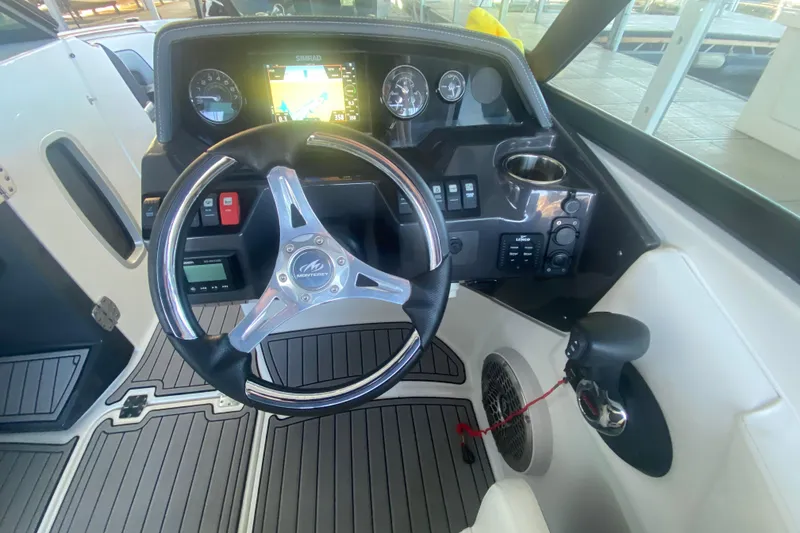 Slide: The Image of Cockpit of 2022 Monterey M-65 boat with steering wheel and navigation display. - 16