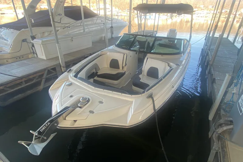 The Image of 2022 Monterey M-65 boat docked, featuring sleek design and spacious seating. - 2