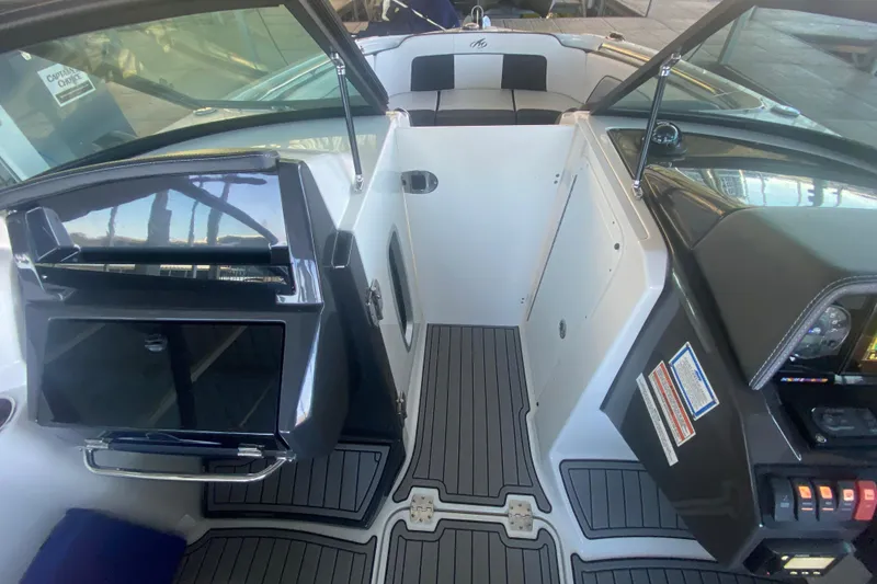Slide: The Image of Interior view of 2022 Monterey M-65 boat cockpit with modern dashboard and seating. - 20