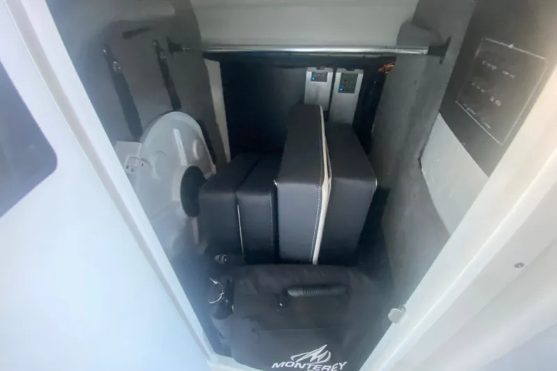 Slide: The Image of Storage compartment in a 2022 Monterey M-65 boat with cushions and equipment. - 21