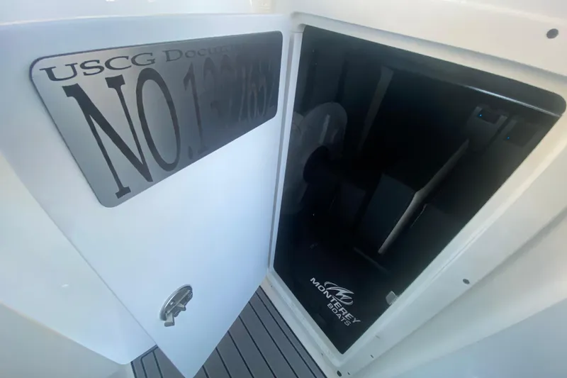 Slide: The Image of Open door on 2022 Monterey M-65 boat showing interior with USCG documentation number. - 22