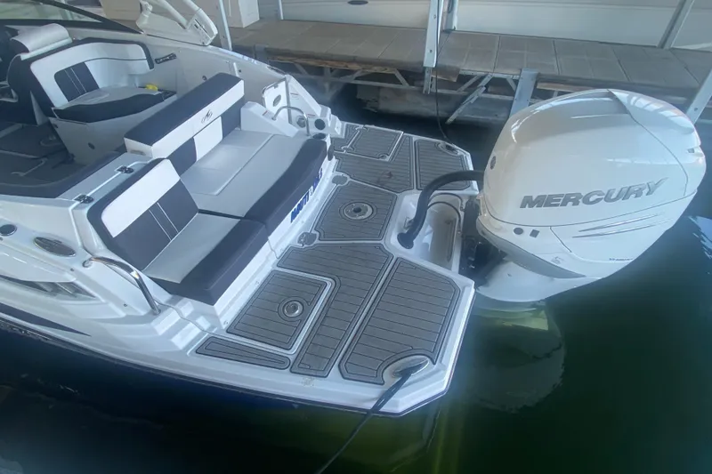 Slide: The Image of 2022 Monterey M-65 boat with Mercury outboard engine, featuring spacious seating and deck. - 3