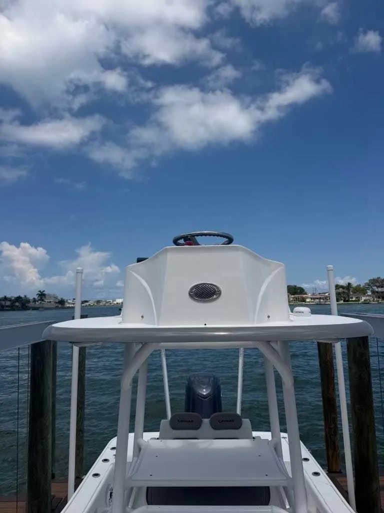 Slide: The Image of A Caymas 26 HB boat with an elevated helm station, docked on a sunny day. - 10