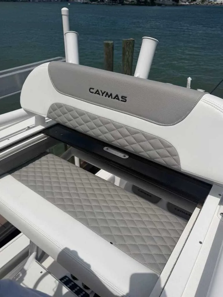Slide: The Image of The 2026 Caymas 26 HB features an elegant, cushioned bench seat with quilted pattern and backrest. - 8