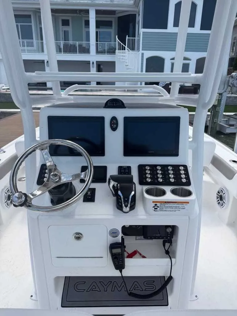 Slide: The Image of The image shows the helm of a Caymas 26 HB boat with modern instruments and controls. - 7
