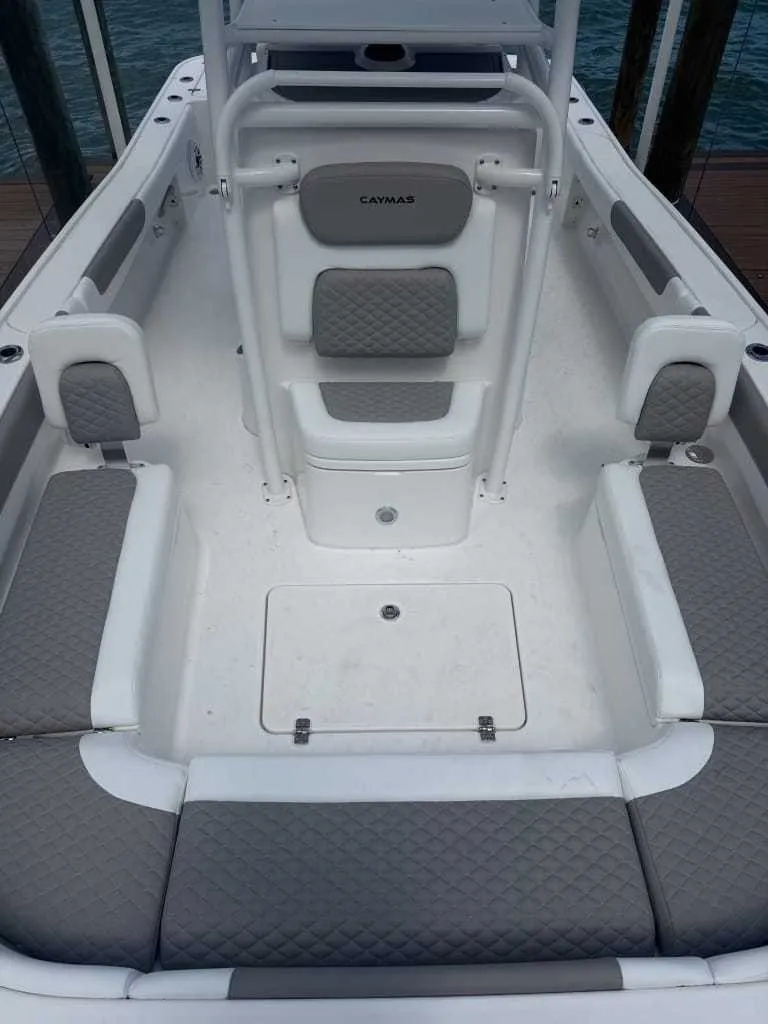 Slide: The Image of The image shows the cockpit of a 2026 Caymas 26 HB boat with gray upholstery. - 3
