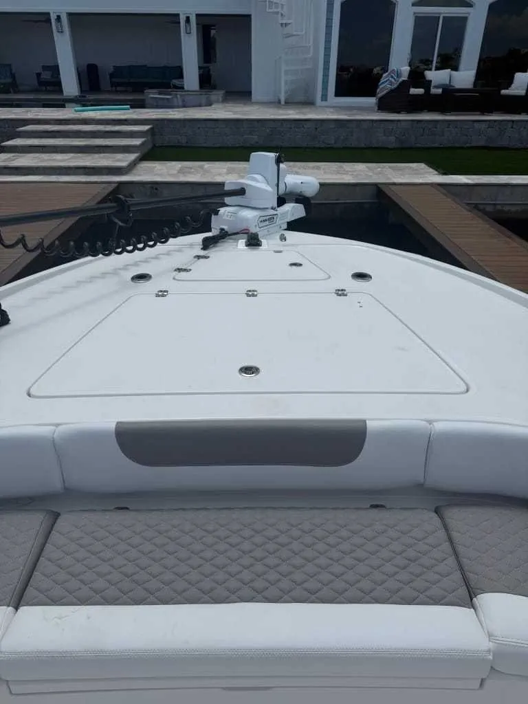 Slide: The Image of The image shows the bow of a Caymas 26 HB boat with cushions and a motor. - 5