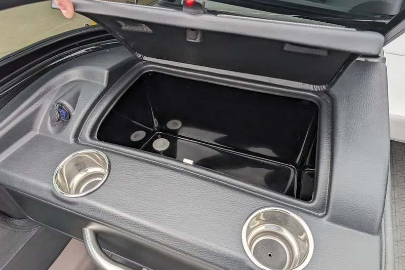 Slide: The Image of 2024 Crownline 240 SS LPX boat storage compartment with cup holders and sleek design. - 10