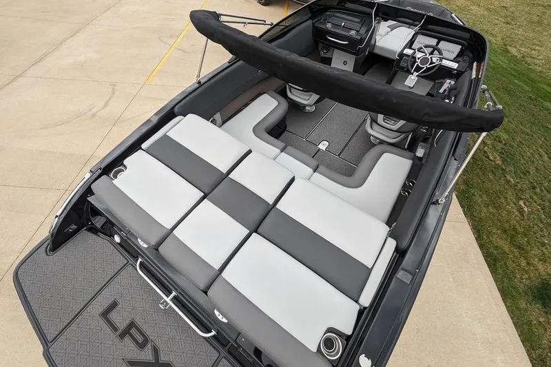 Slide: The Image of 2024 Crownline 240 SS LPX boat interior with sleek seating and modern dashboard design. - 5