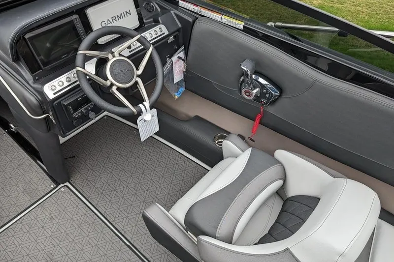 Slide: The Image of 2024 Crownline 240 SS LPX boat interior with Garmin navigation and modern steering wheel. - 7