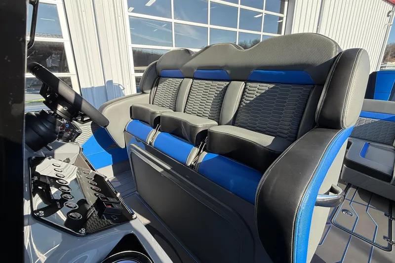 Slide: The Image of 2026 Sunsation 34 CCX boat interior with modern seating and steering console. - 13
