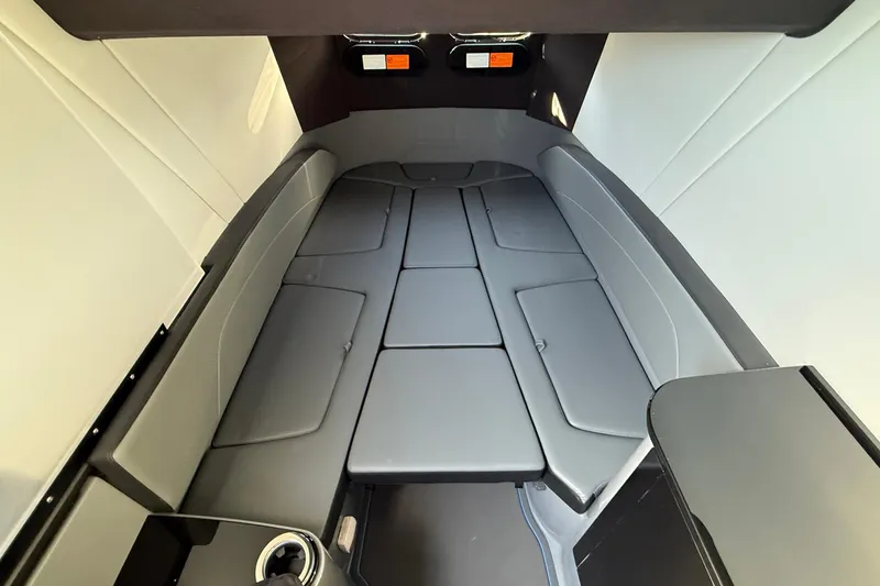 Slide: The Image of 2026 Sunsation 34 CCX cabin interior with sleek, modern seating and storage compartments. - 22