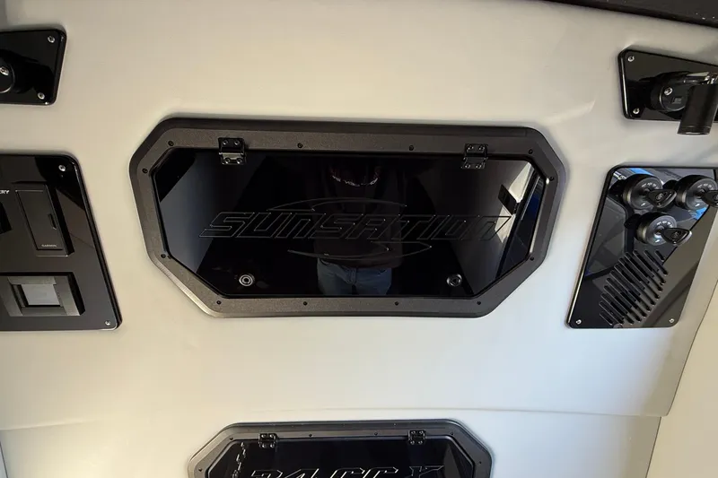 Slide: The Image of 2026 Sunsation 34 CCX dashboard with sleek black panels and controls. - 25