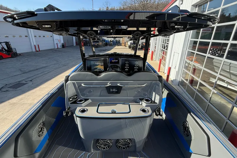 Slide: The Image of 2026 Sunsation 34 CCX boat interior with advanced dashboard and seating, docked at a marina. - 28