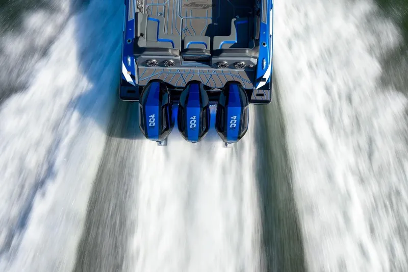 Slide: The Image of 2026 Sunsation 34 CCX boat with triple 400 engines speeding on water. - 30