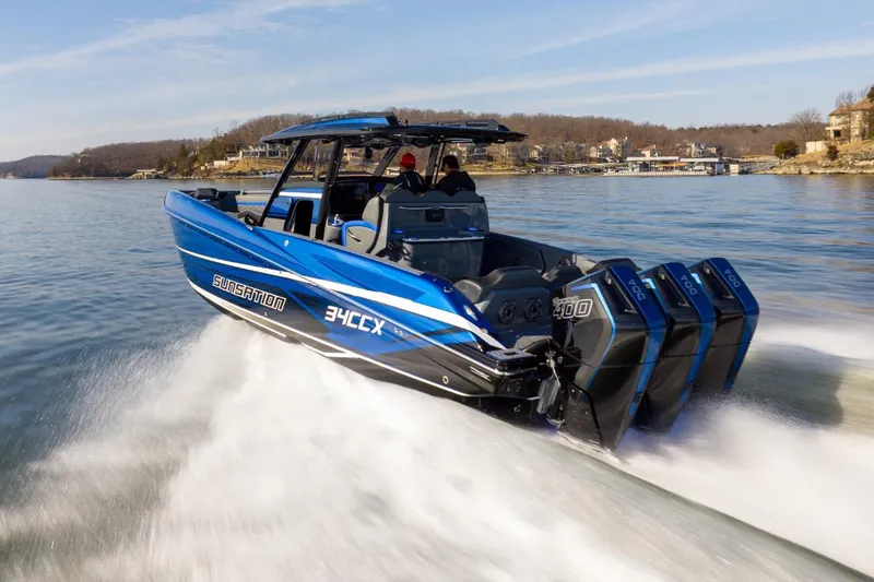 Slide: The Image of 2026 Sunsation 34 CCX speedboat cruising on a lake with powerful engines. - 31