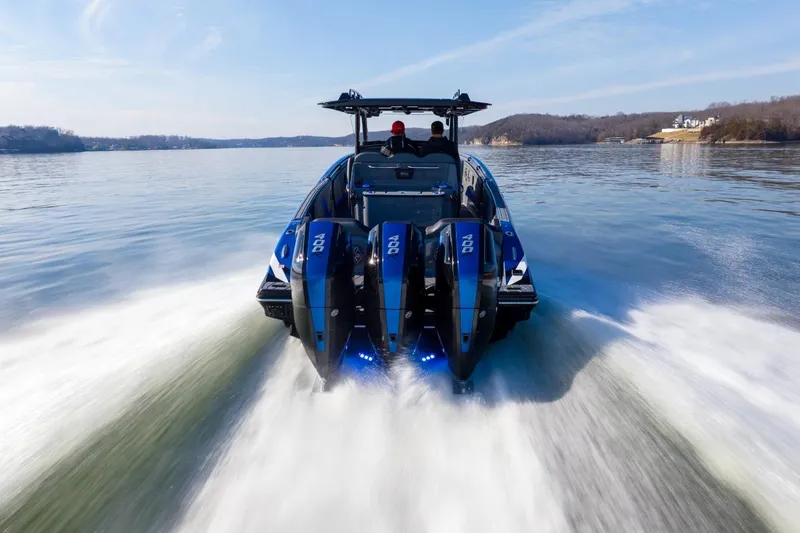 Slide: The Image of 2026 Sunsation 34 CCX speedboat cruising on a serene lake. - 32